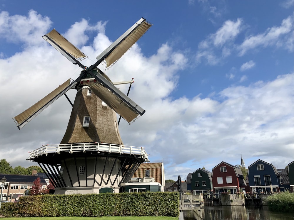 a windmill sitting on top of a lush green field