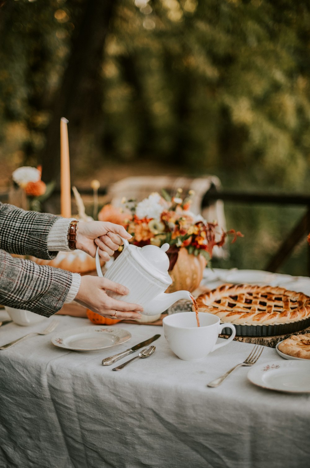 a table topped with a pie covered in frosting