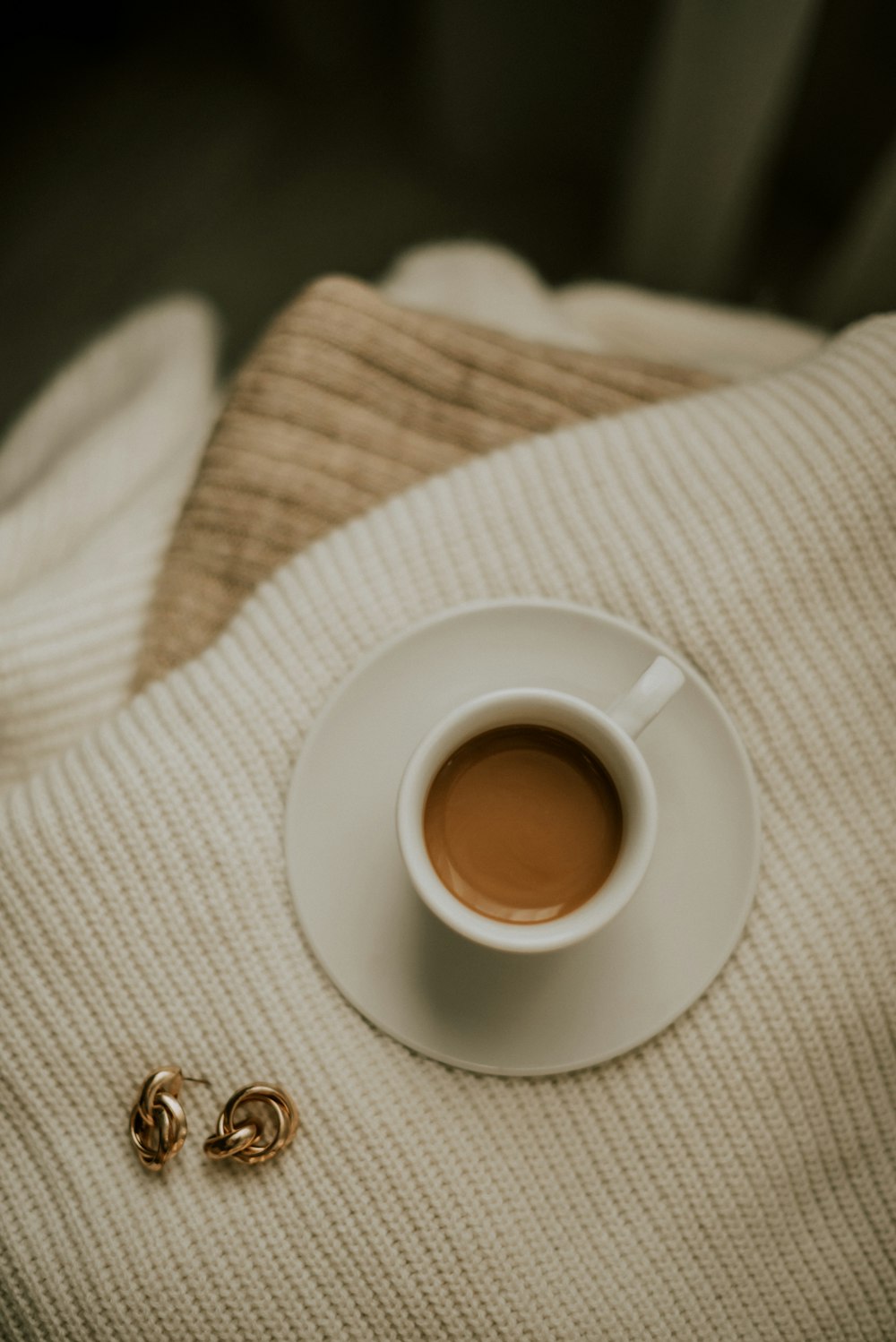 a cup of coffee sitting on top of a white saucer