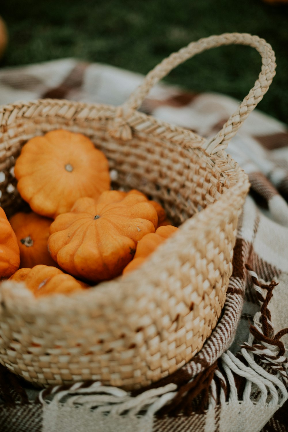 a basket filled with oranges sitting on top of a table