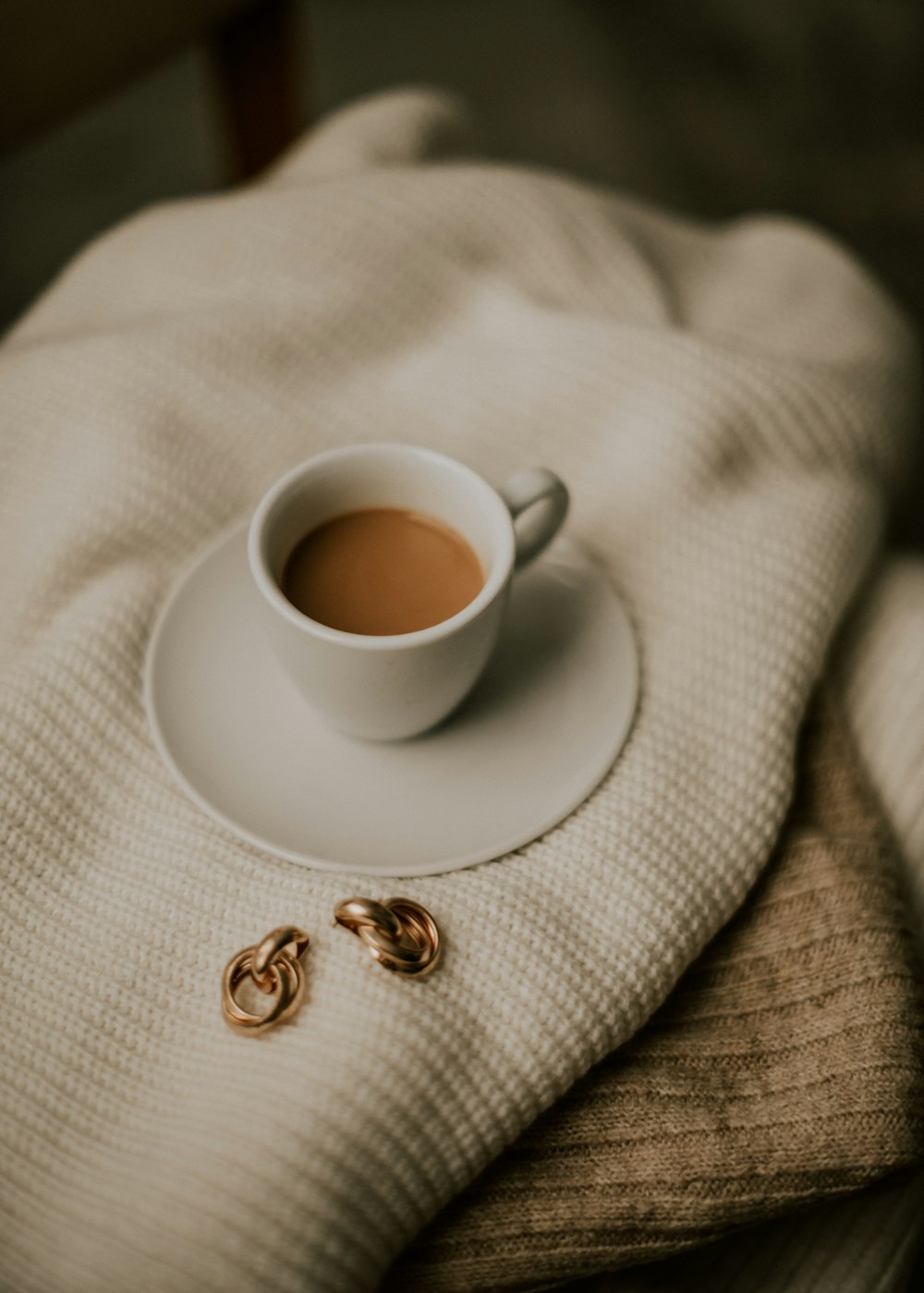 Una taza de café encima de un platillo blanco