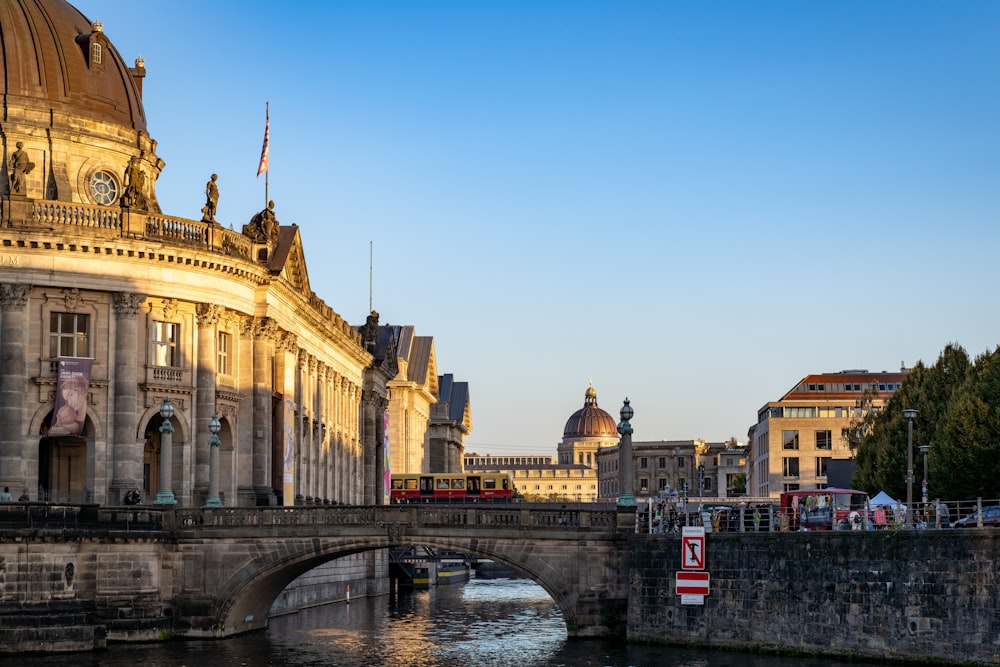 a bridge over a body of water next to a building