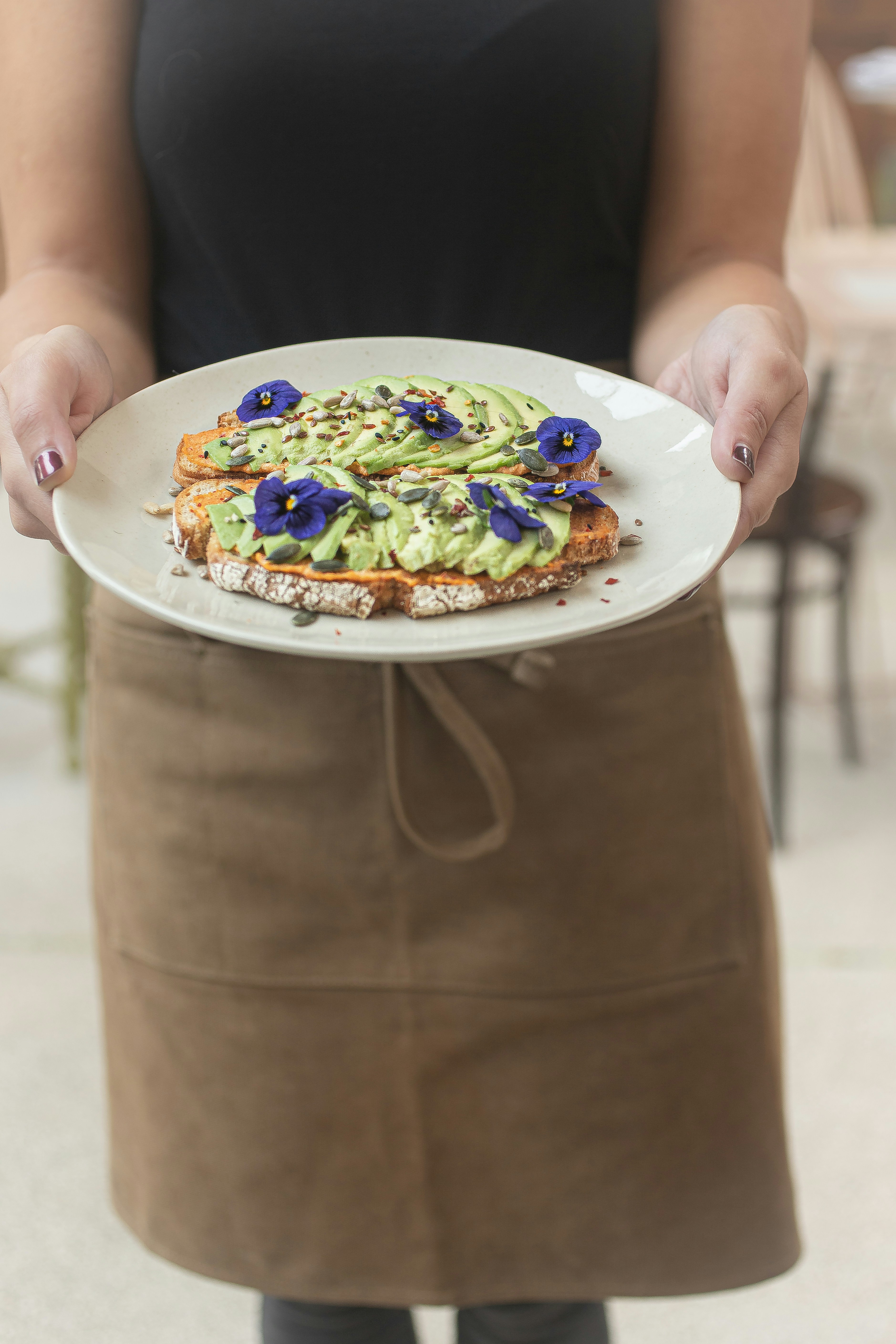 a person holding a plate with food on it