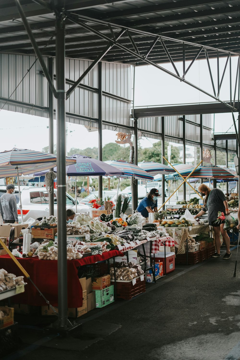 a group of people shopping at an outdoor market