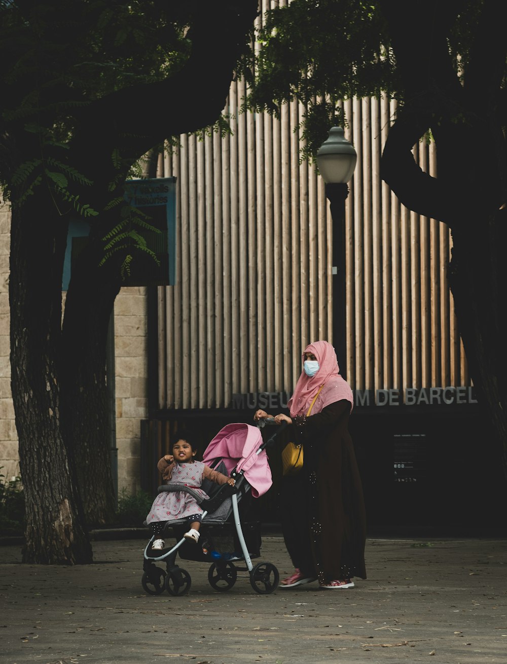 a woman pushing a stroller with a child in it