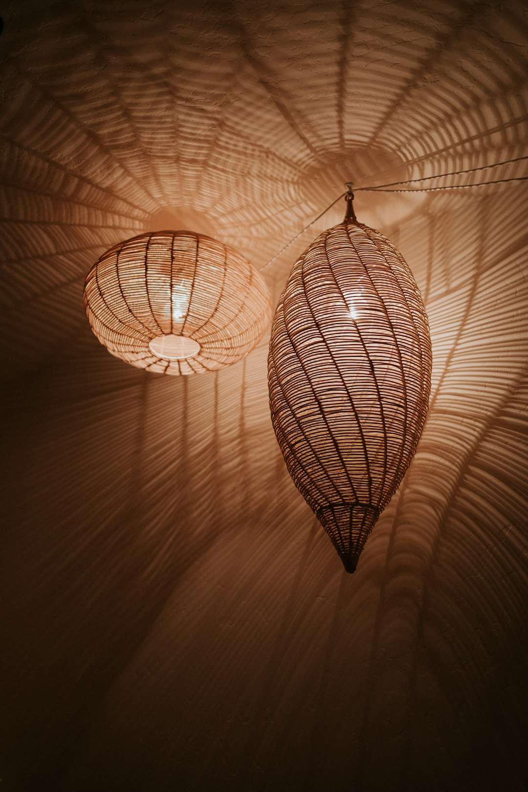 Glowing woven rattan lamp casting warm patterned light