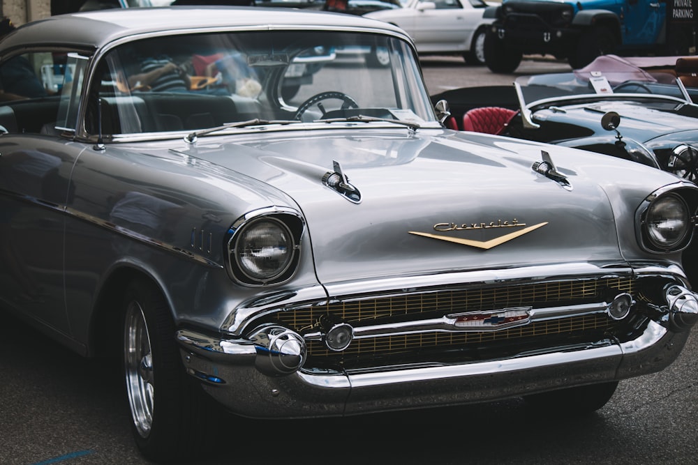 a classic car is parked in a parking lot