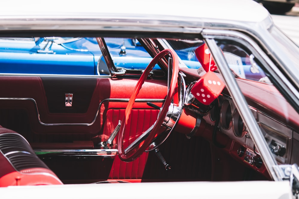 the interior of a car with a red steering wheel