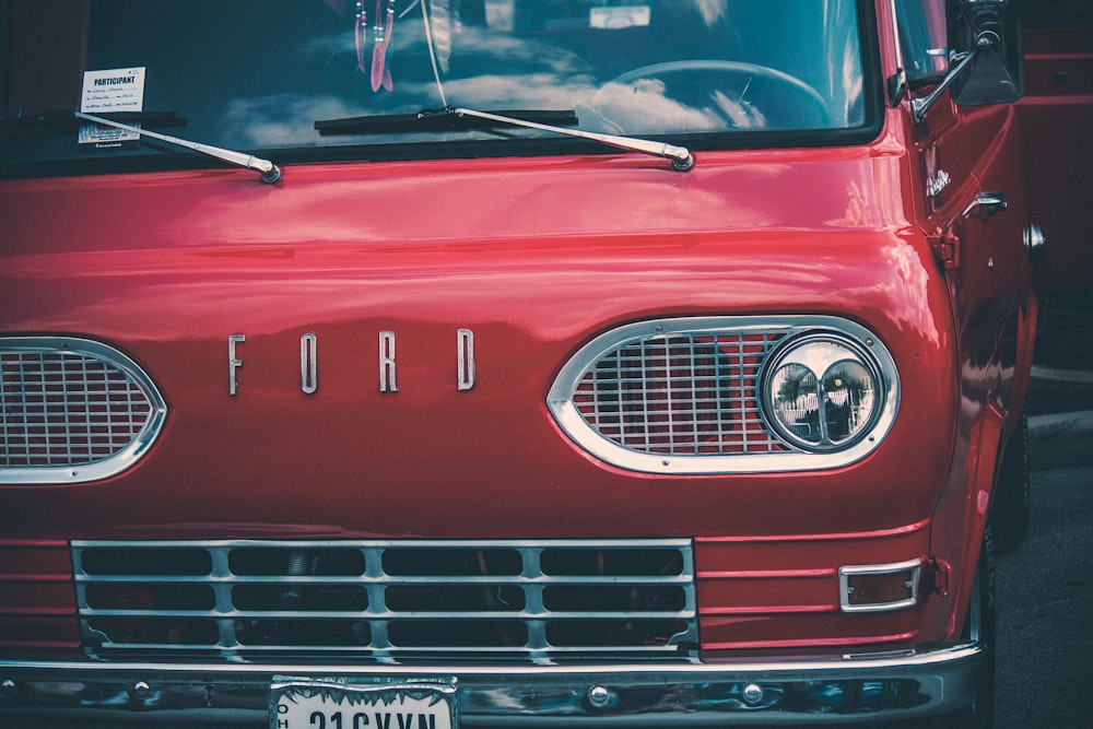 a red ford truck parked in a parking lot