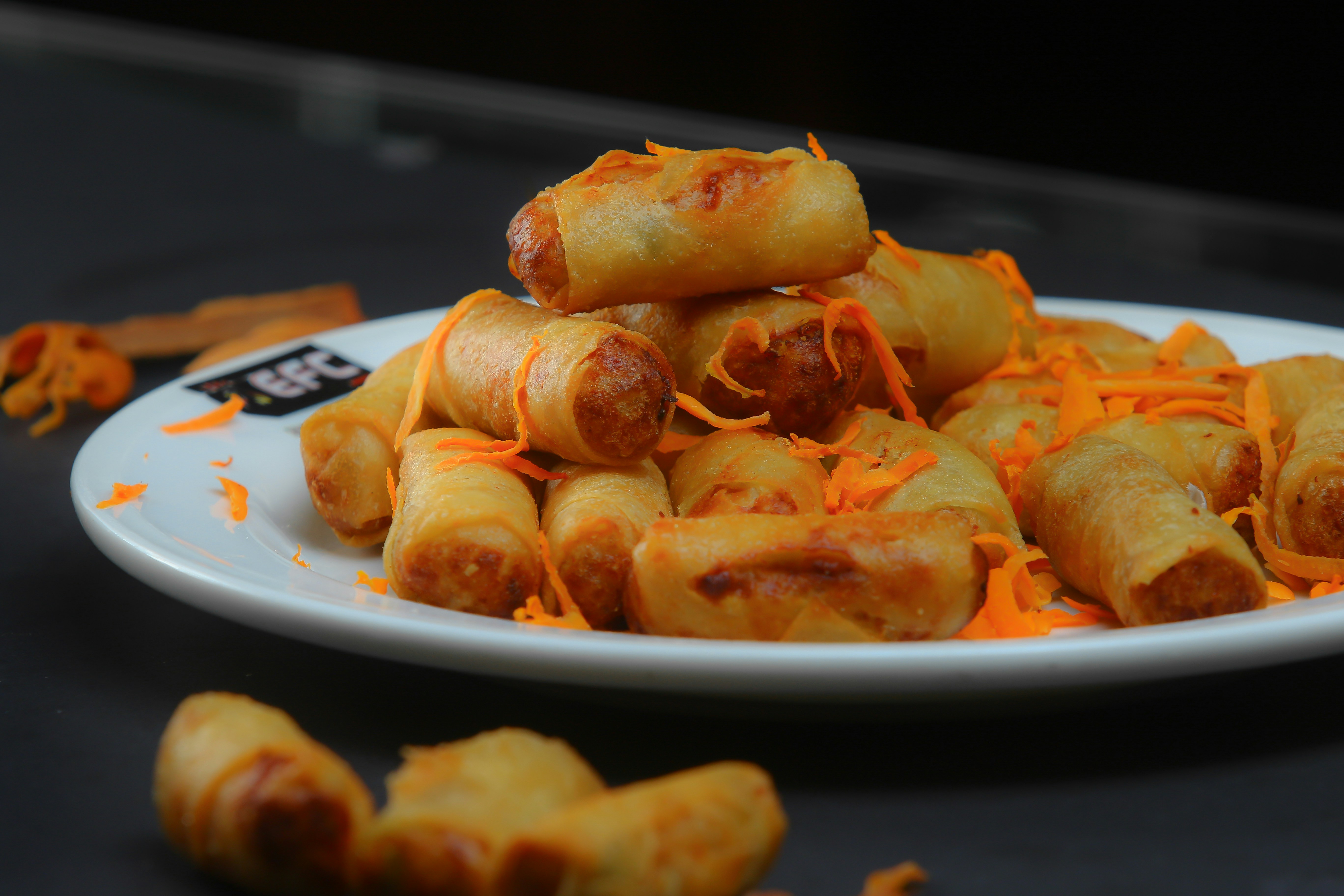 Plate of fried spring rolls with carrot
