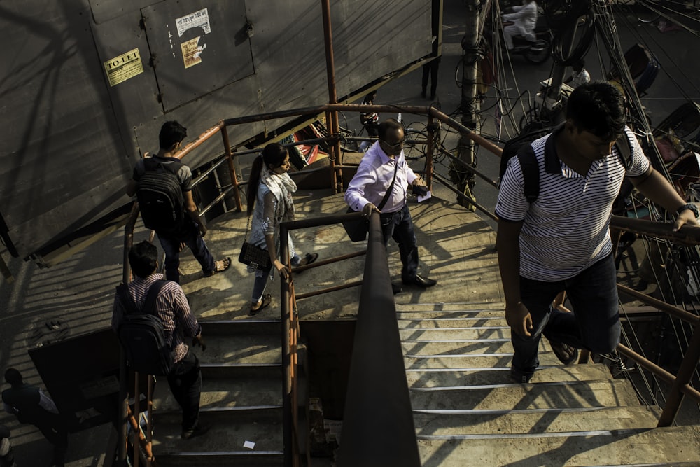 a group of people walking up a flight of stairs