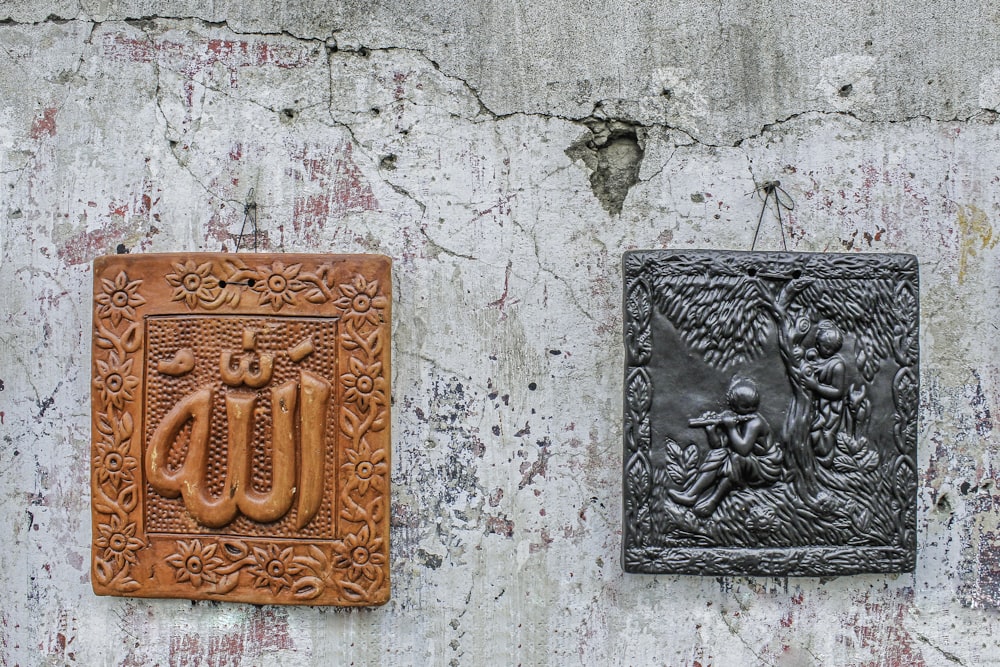 a couple of metal plaques mounted to the side of a wall