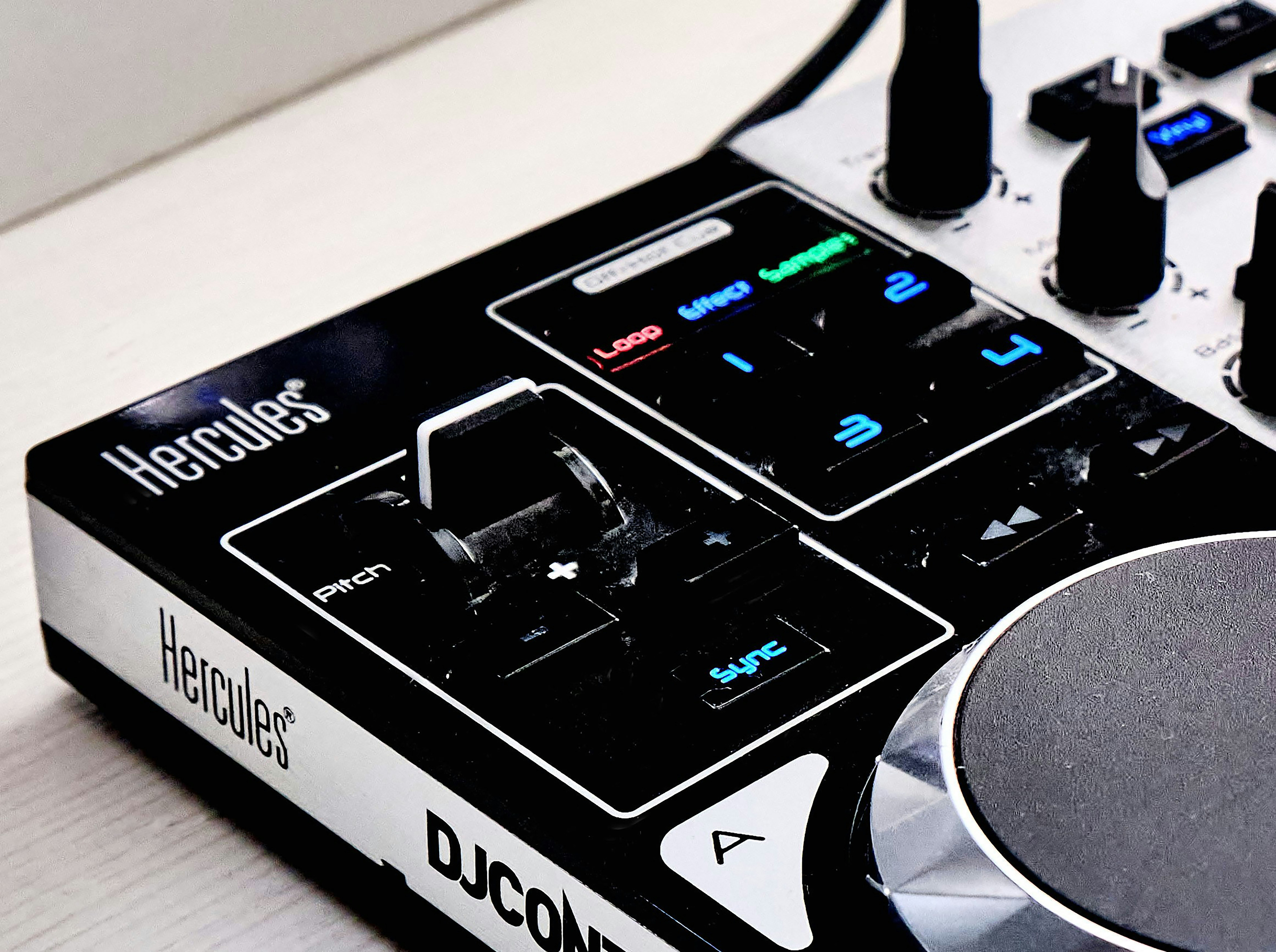 a dj controller sitting on top of a white table