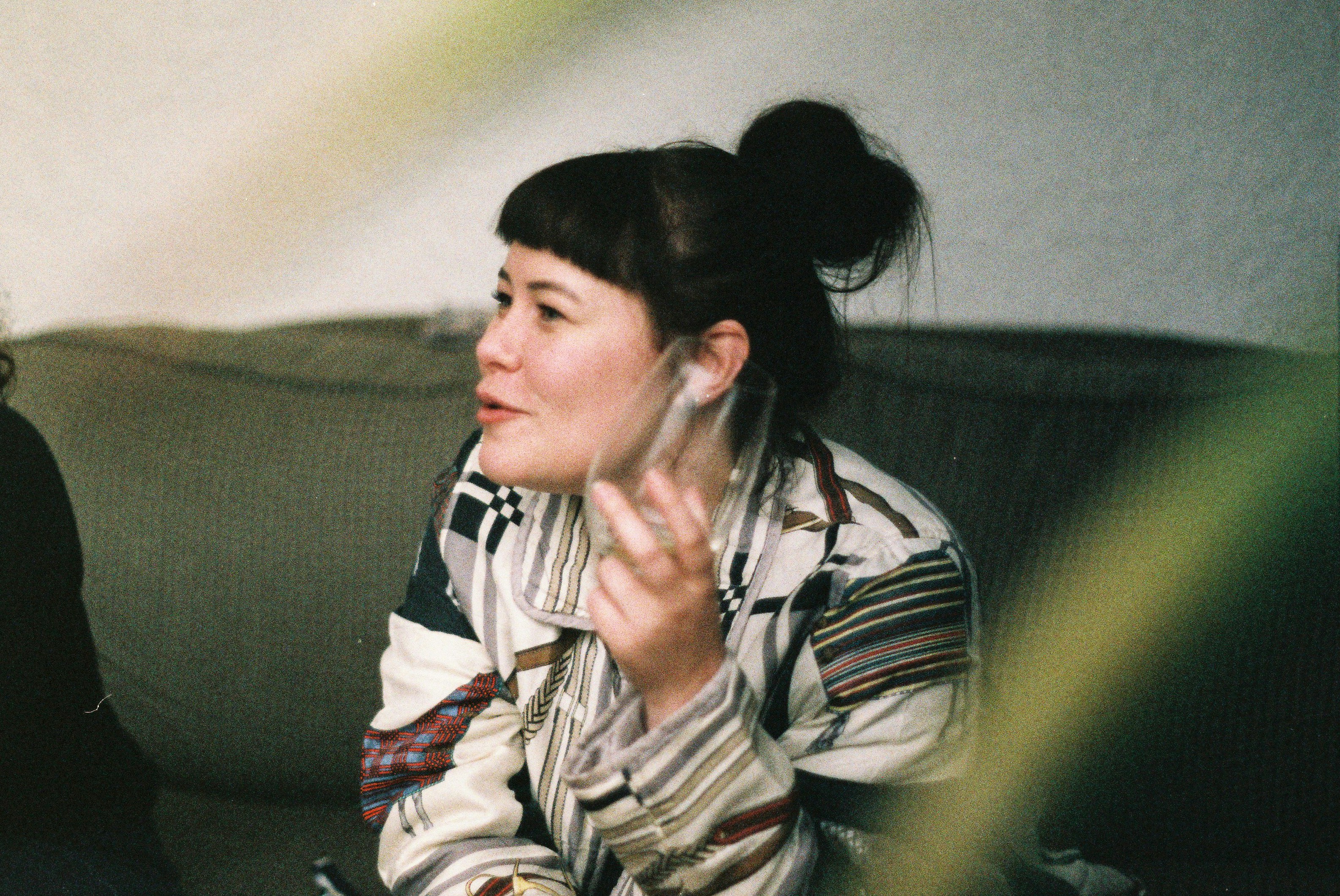 two women sitting on a couch playing a video game