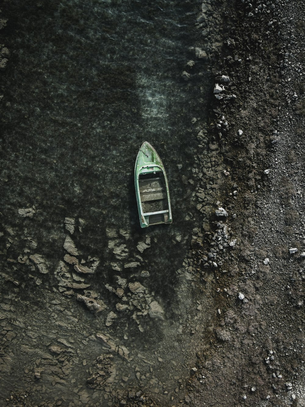 a small boat floating on top of a body of water