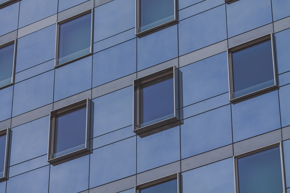 a tall building with many windows and a sky background