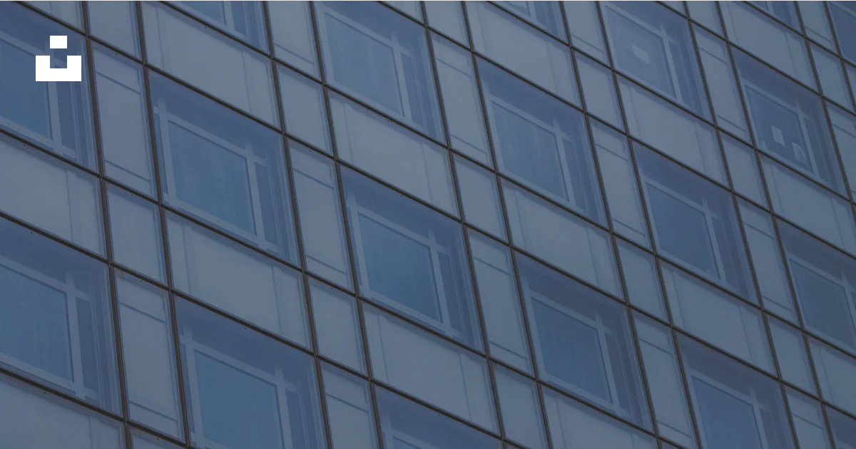 Clock Windows Building A building with many windows and a clock on the side of it photo – Free ...