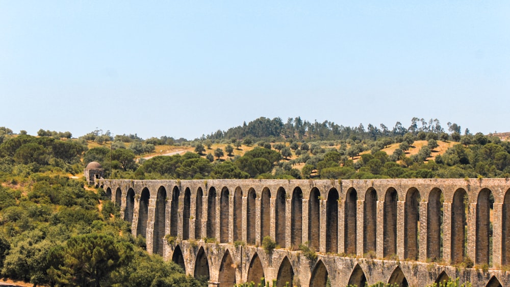 a train traveling over a bridge over a river