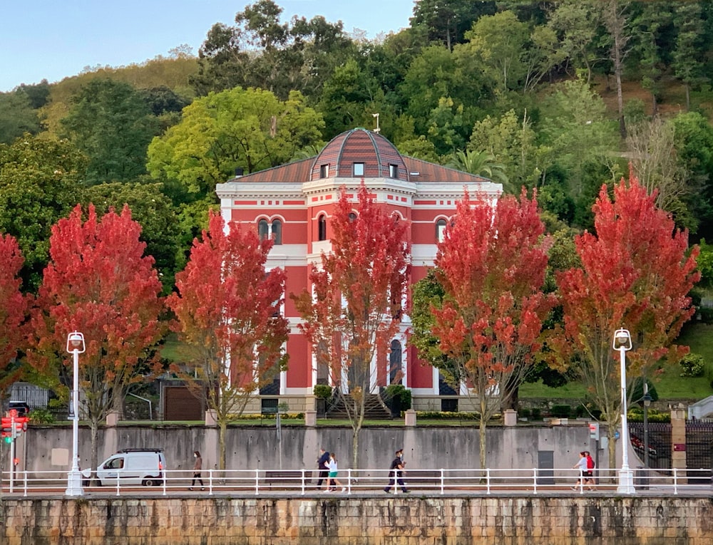 a large red building sitting next to a body of water