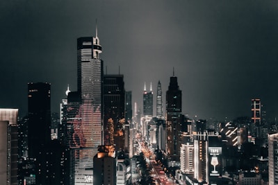 A bustling city skyline at night with illuminated skyscrapers.