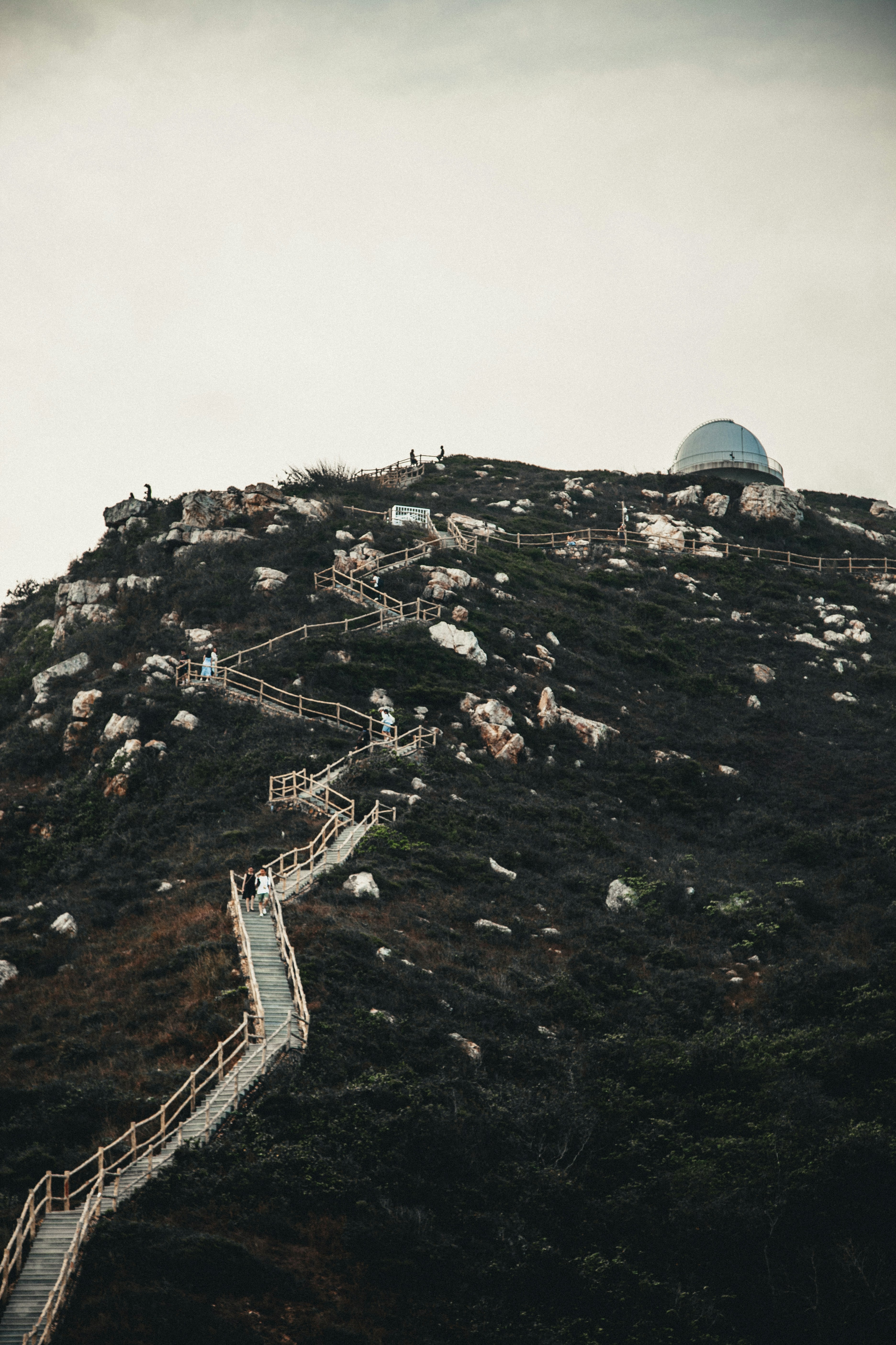 A group of people walking up a steep hill photo – Free Path Image on ...