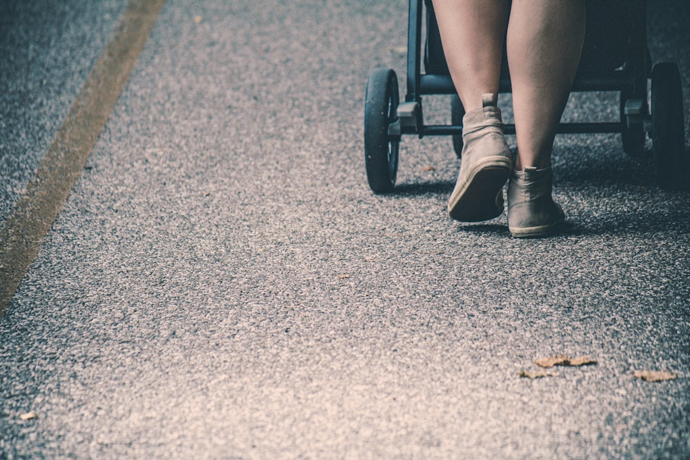 a person in a wheel chair on a road