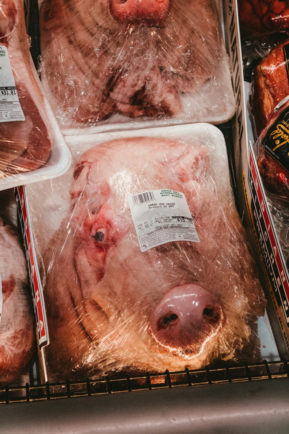 a display of meat in plastic bags in a grocery store