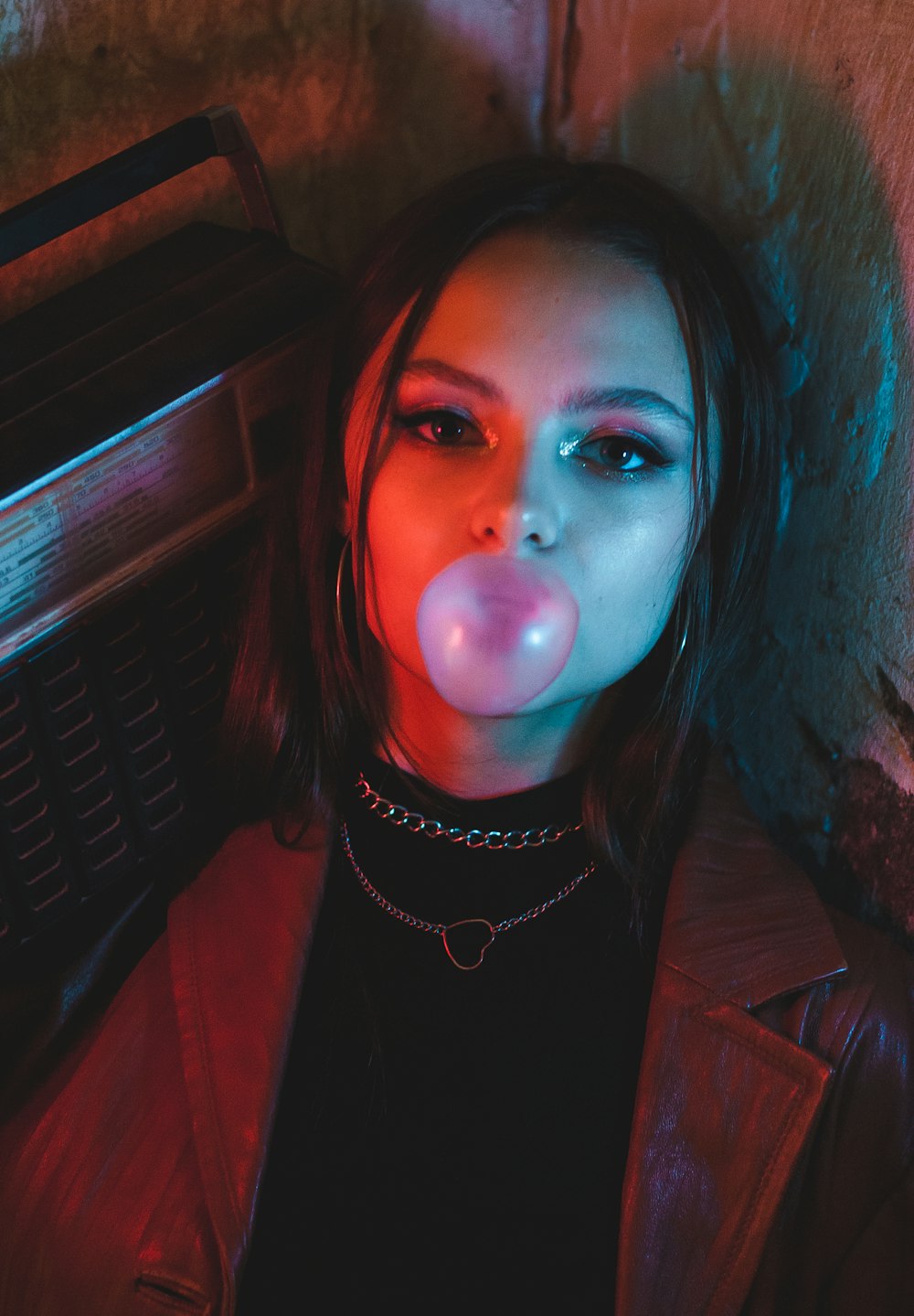 a woman with a bubble gum in her mouth