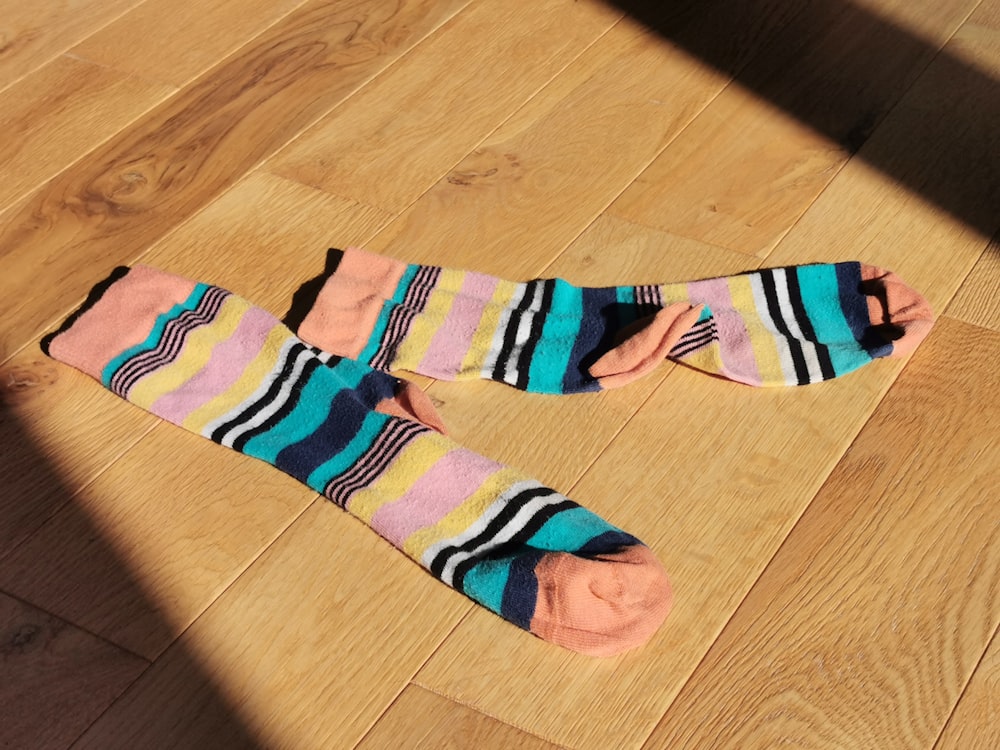 a pair of socks laying on a wooden floor