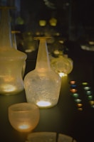 A collection of small glass buttons sparkling under soft light on a wooden table.