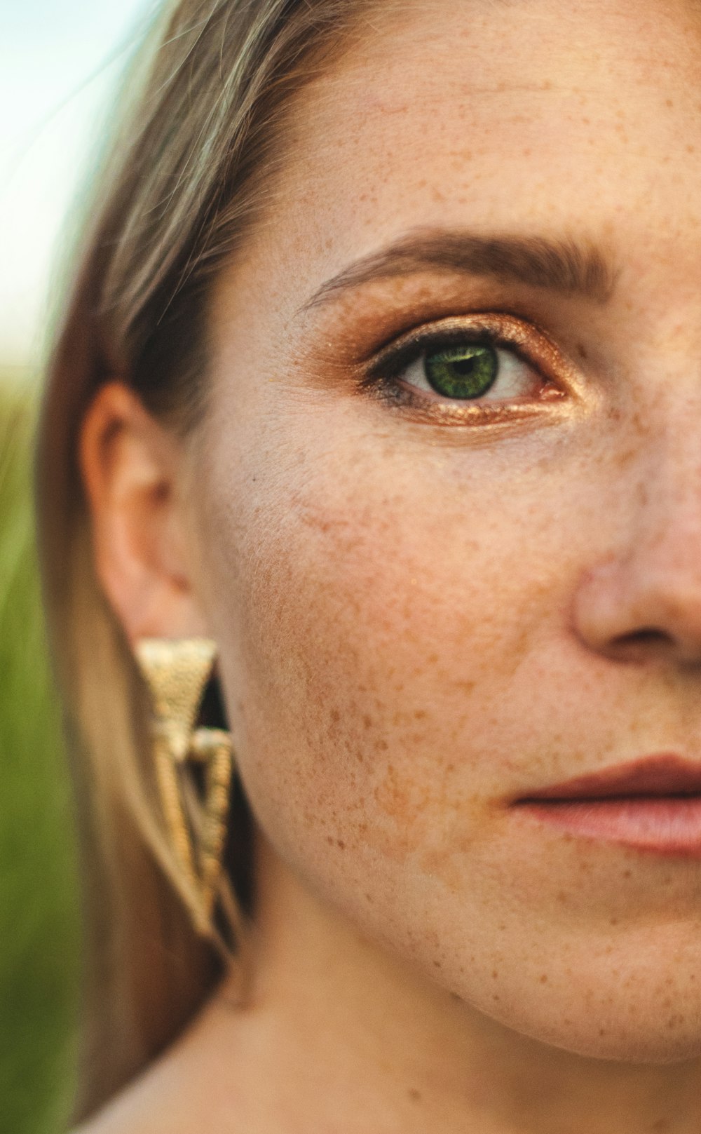 a close up of a woman with freckles on her face