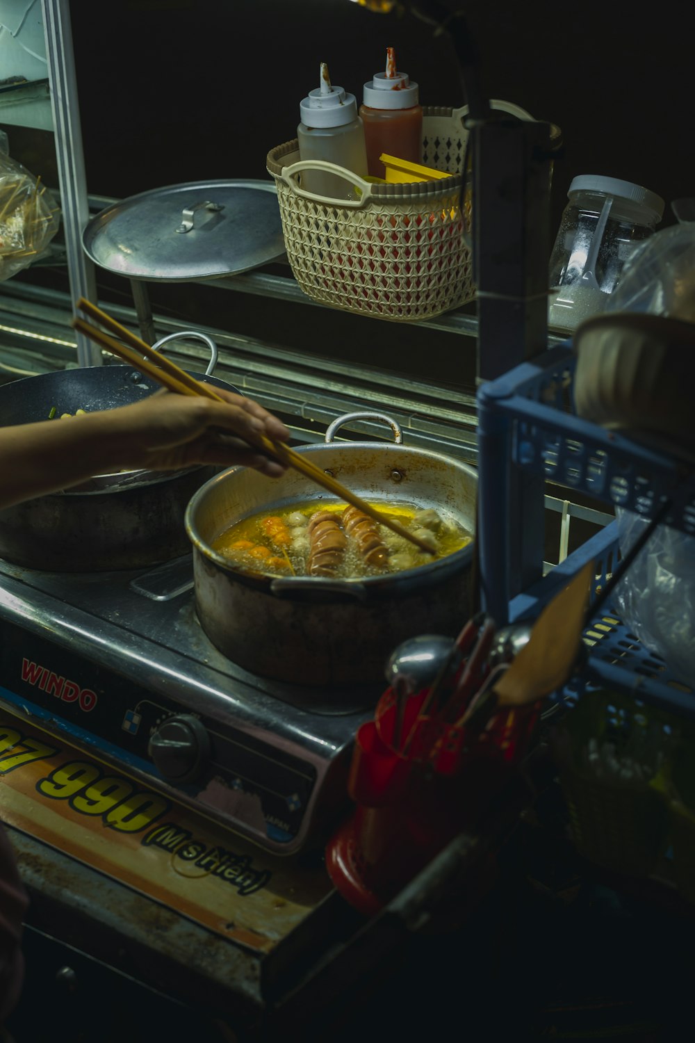 a person cooking food on top of a stove