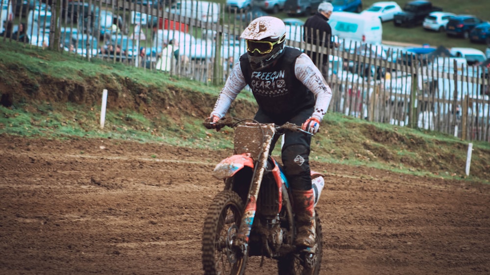 a man riding a dirt bike on top of a dirt field