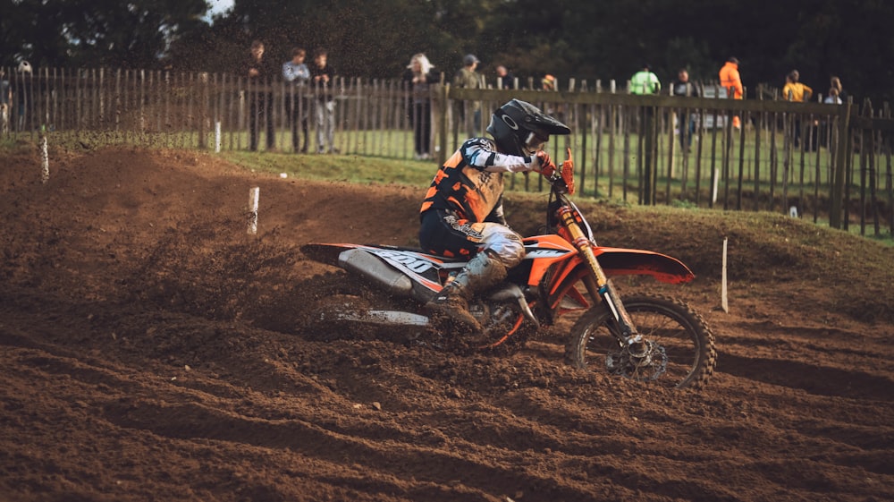 a man riding a dirt bike on top of a dirt field