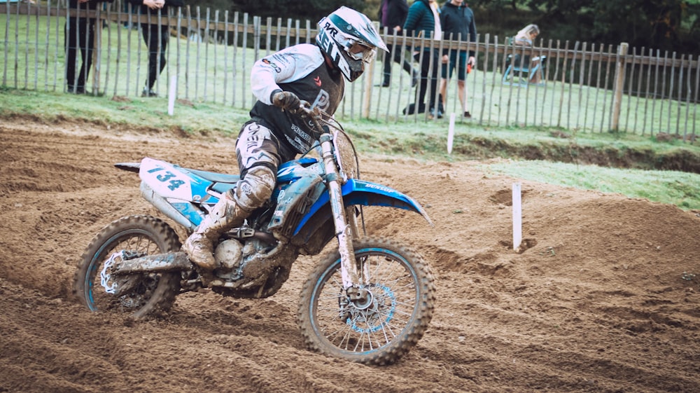 a person riding a dirt bike on a dirt track