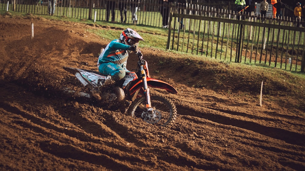 a person riding a dirt bike on a dirt track