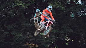 a man riding a dirt bike through the air