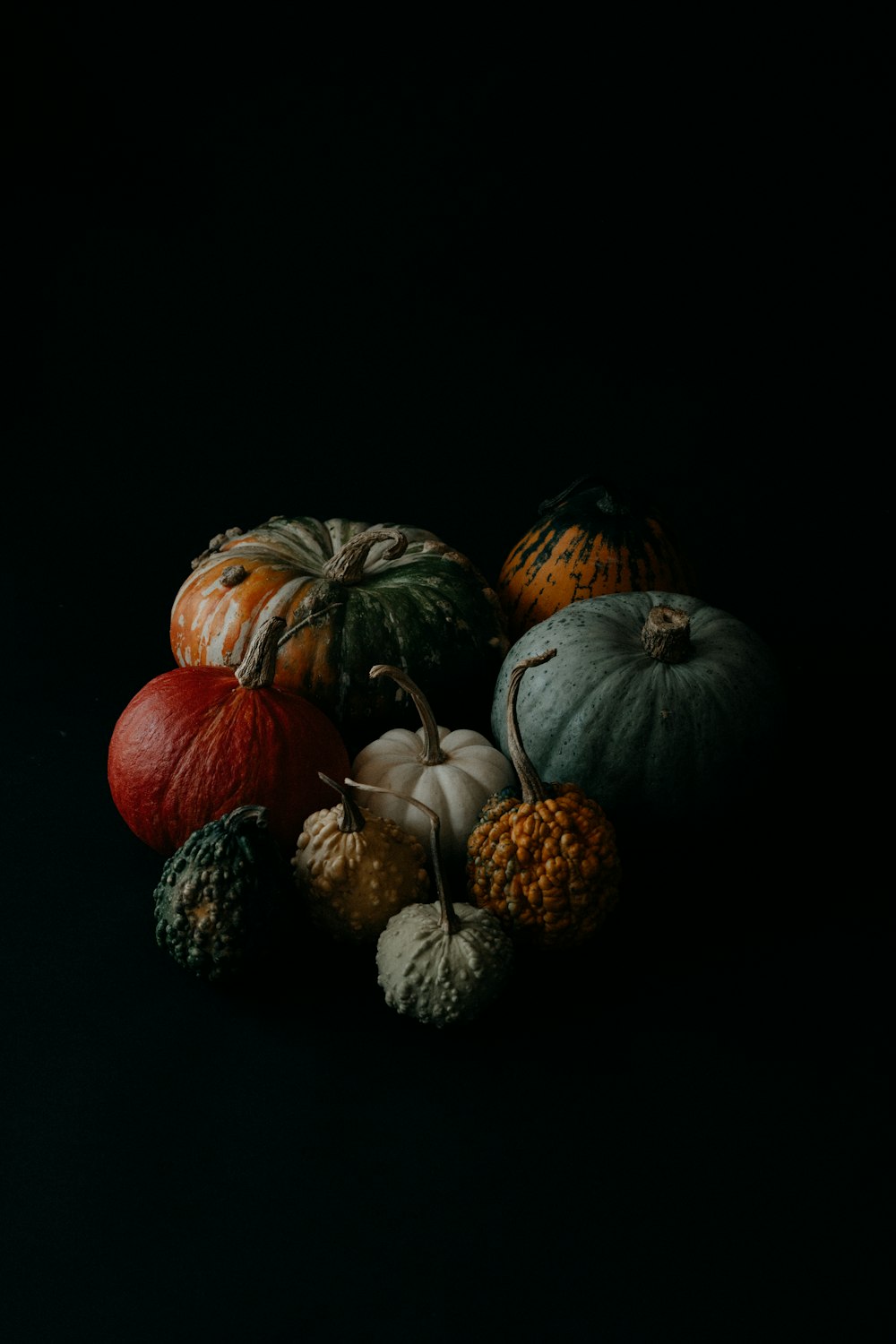 a group of pumpkins sitting on top of each other