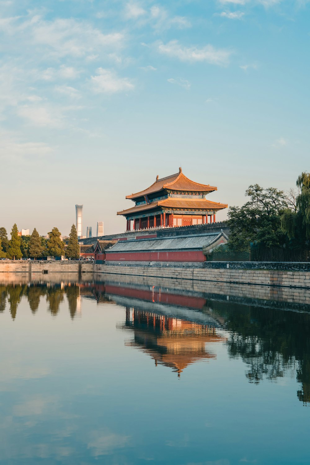 a large body of water with a building in the background