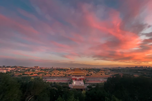 The majestic Gyeongbokgung Palace glowing under a sunset sky.