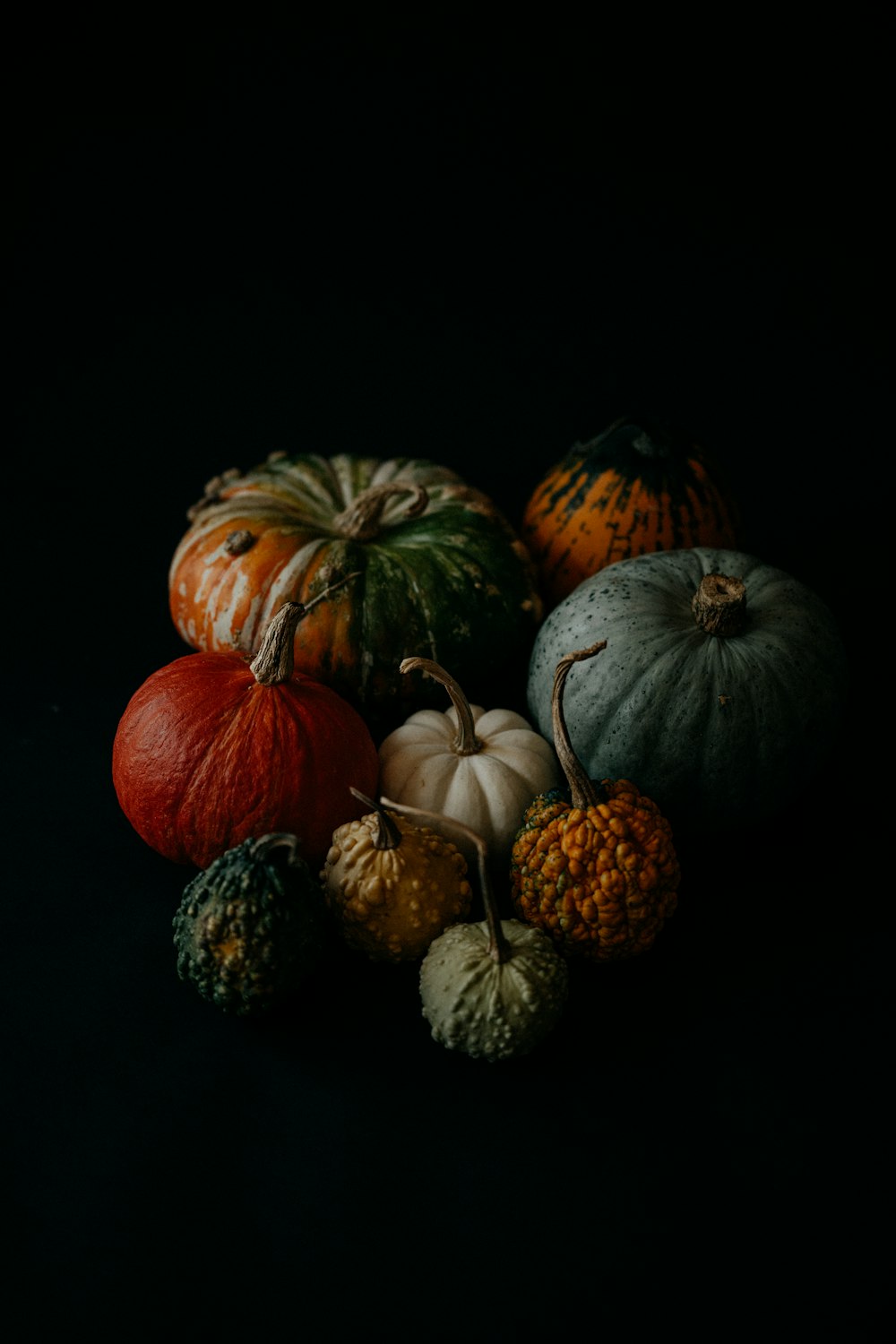 a group of pumpkins sitting on top of each other
