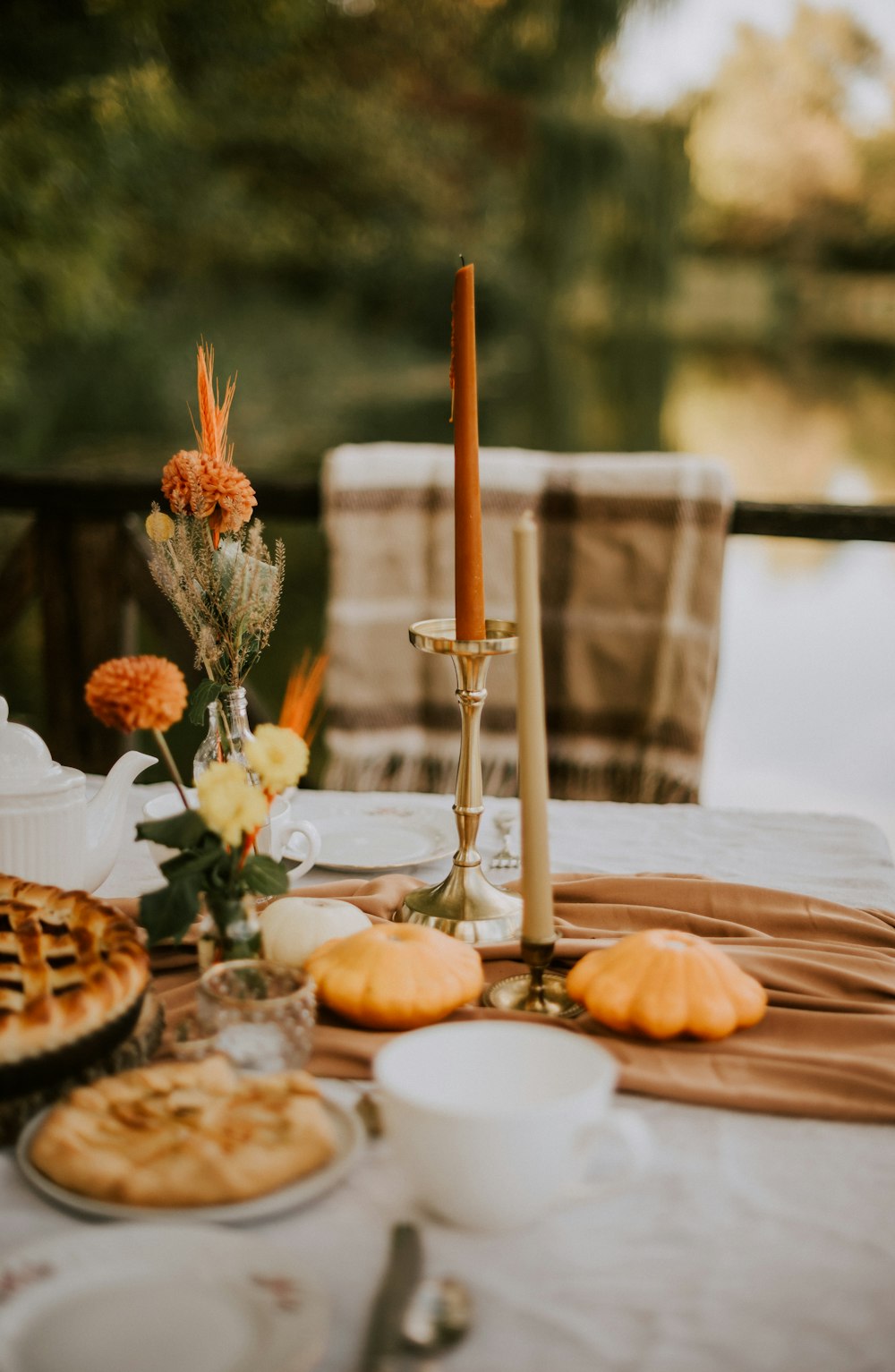 a table topped with a pie next to a candle