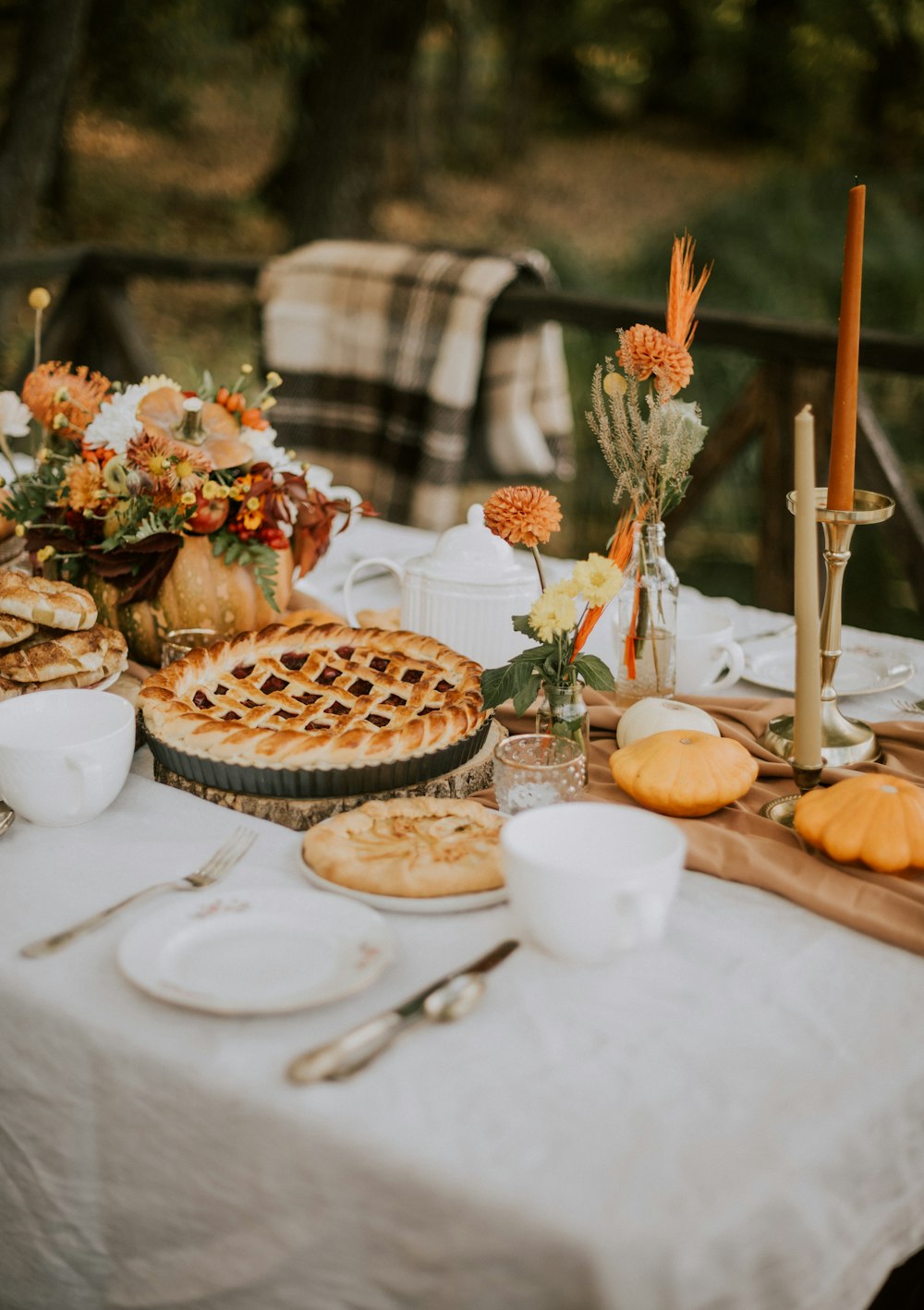 a table topped with pies and other food