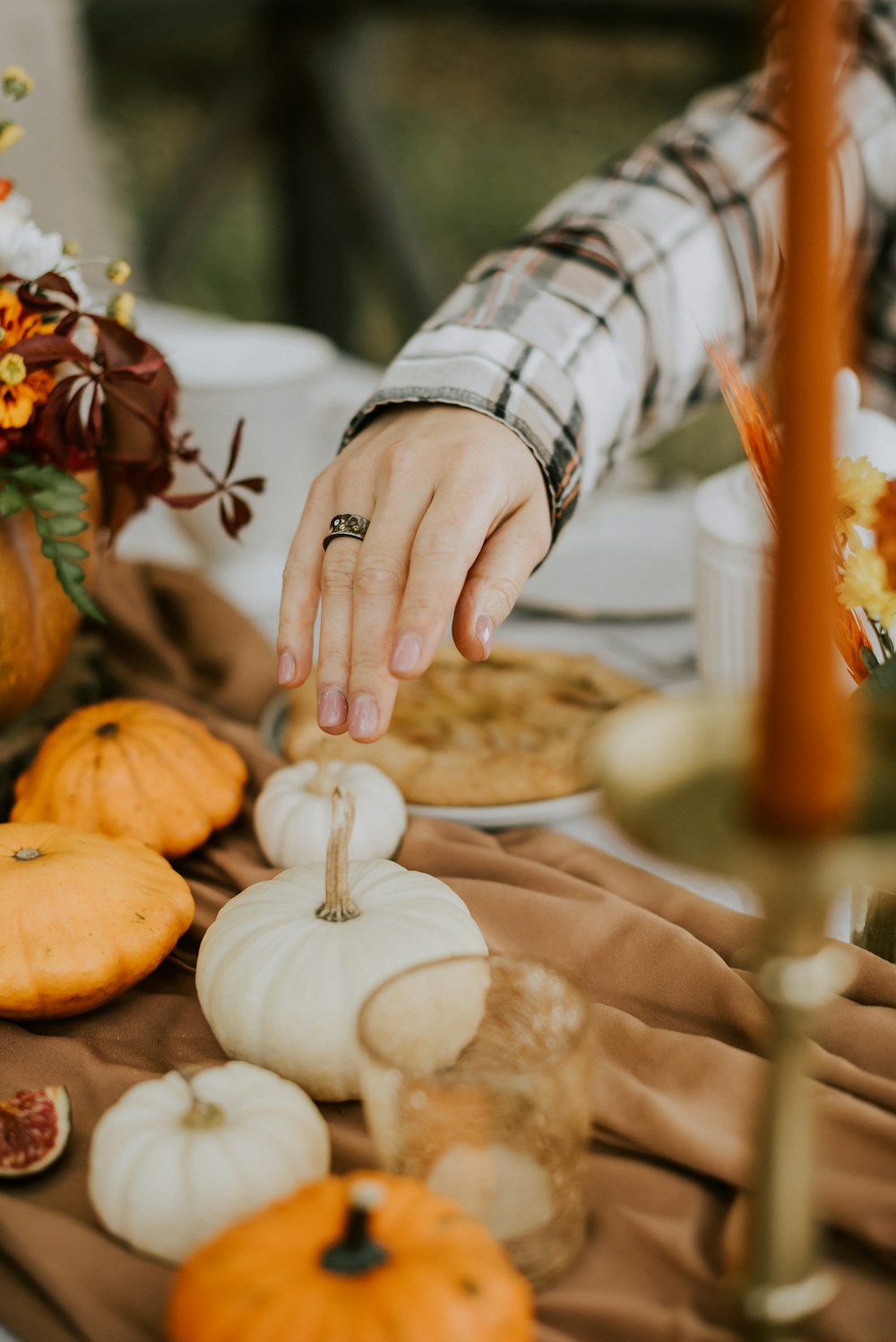 a person reaching for a piece of food on a table