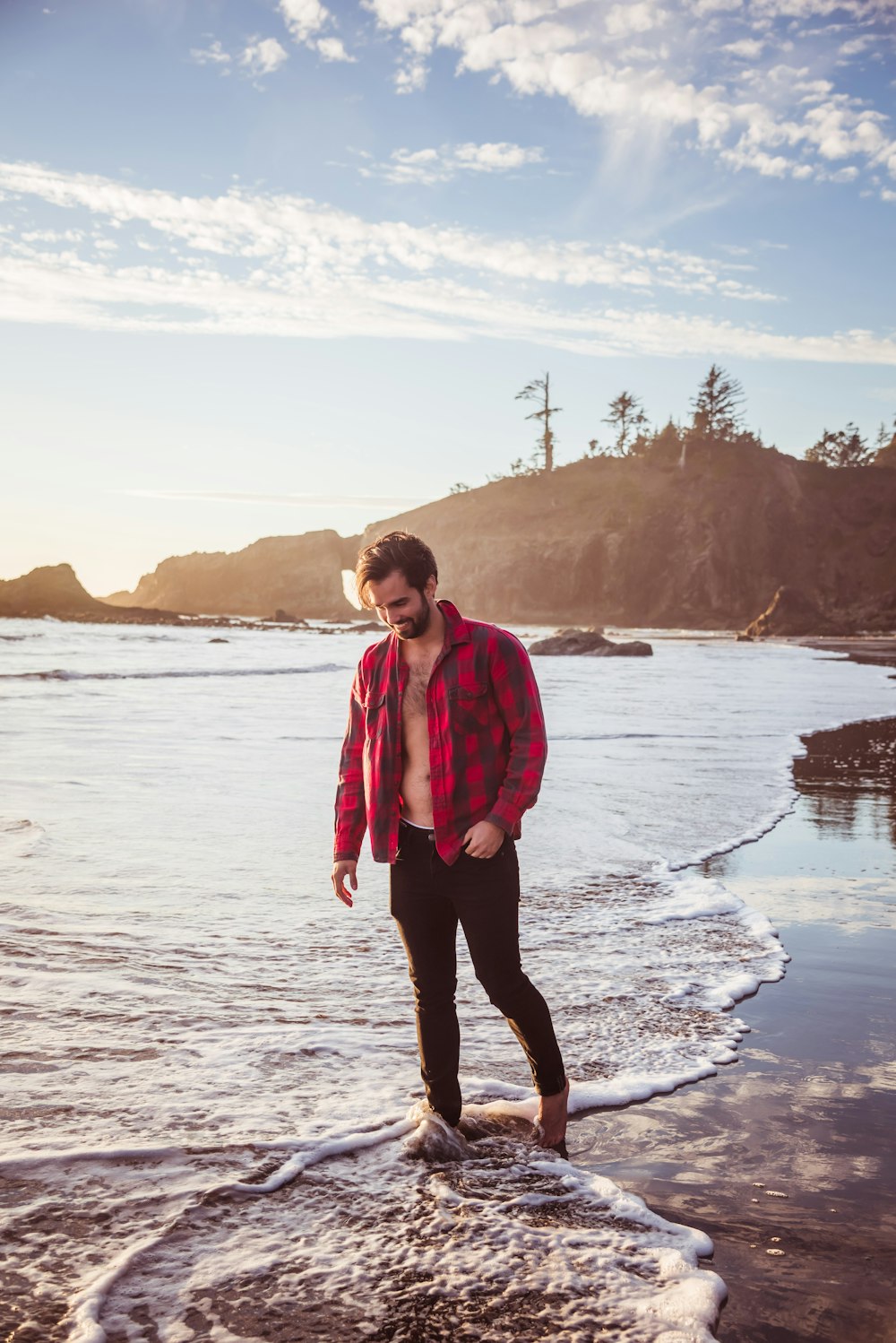 a man standing in the water at the beach