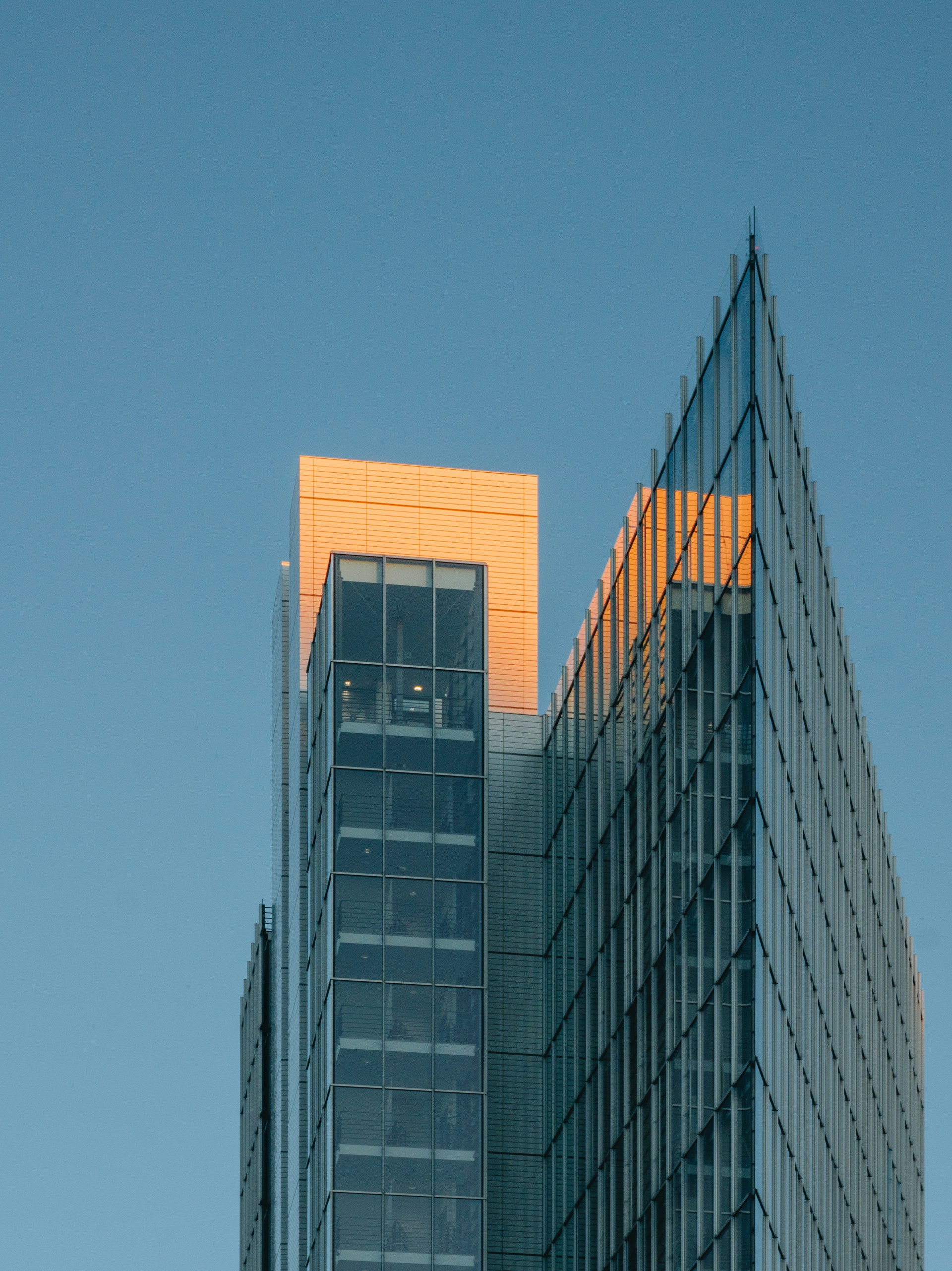 a very tall building with a plane flying in the sky