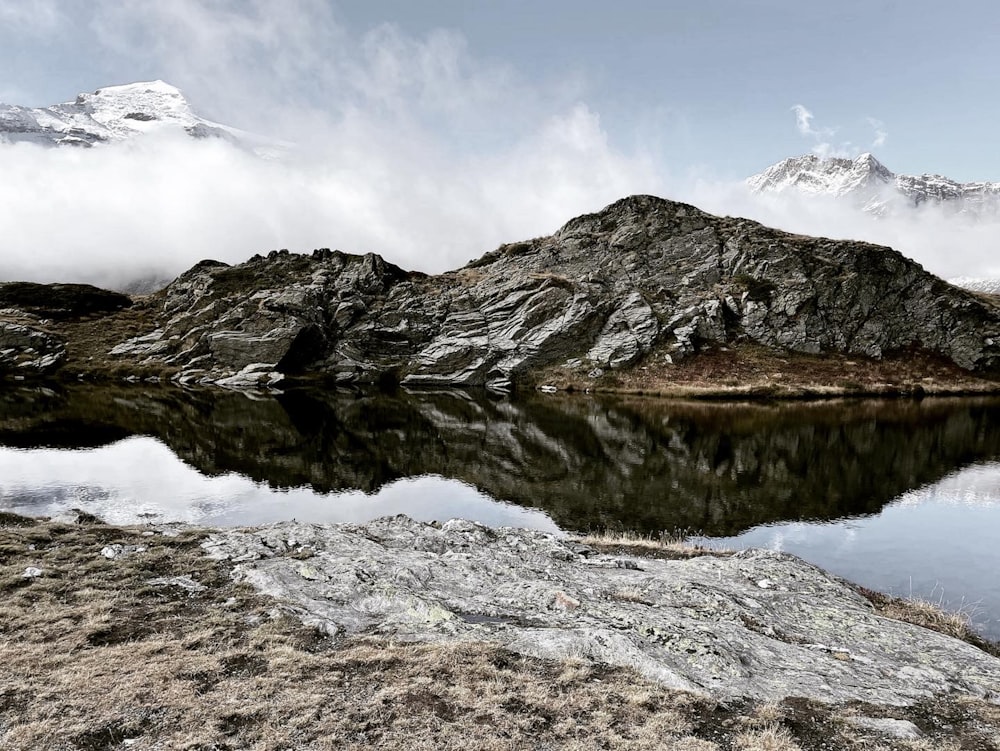 a mountain range with a lake in the foreground