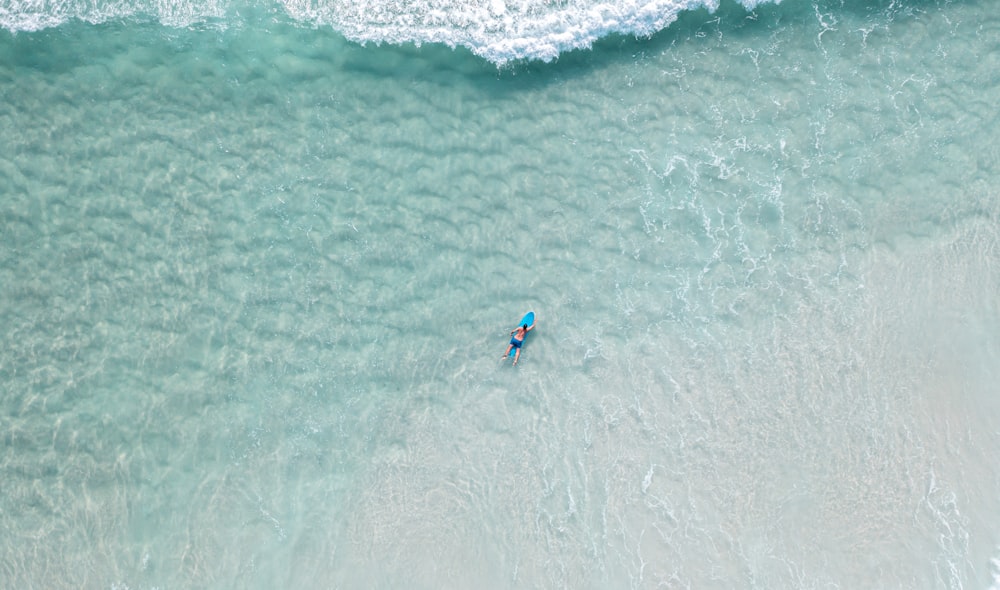 a man riding a wave on a surfboard in the ocean