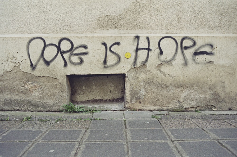 graffiti on the side of a building that says hope is hope