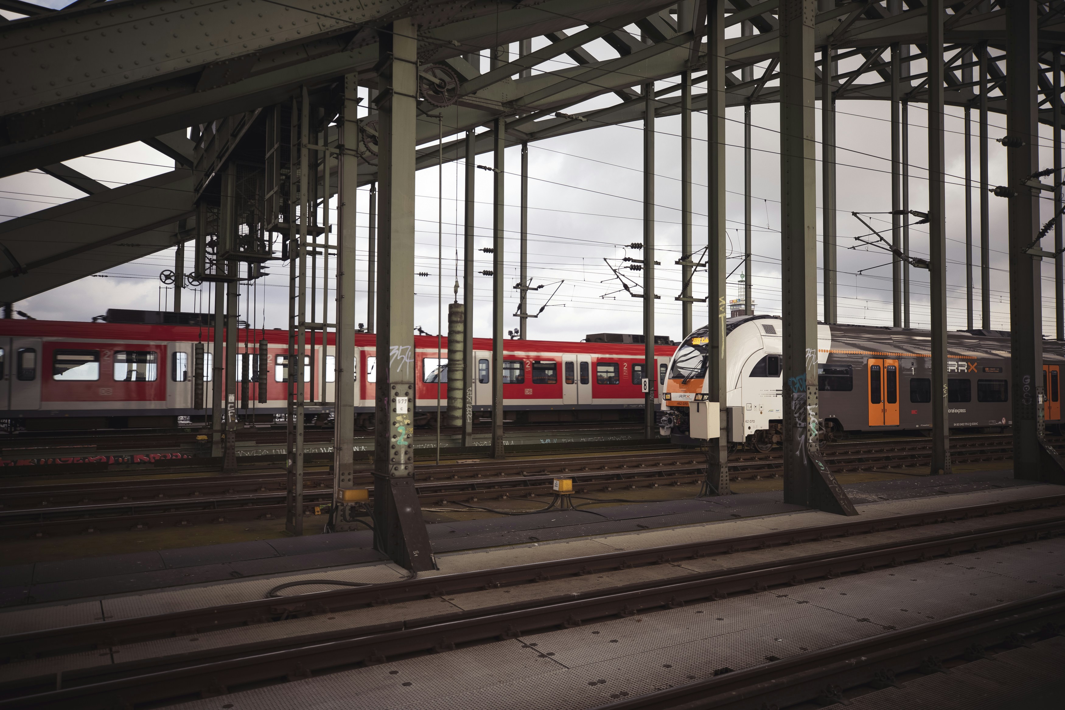 a red and white train traveling down train tracks